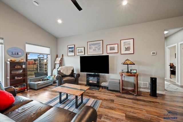 living room featuring hardwood / wood-style flooring and high vaulted ceiling