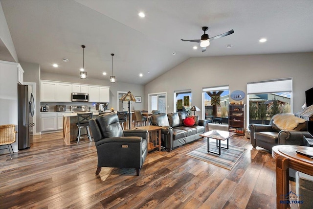 living room featuring ceiling fan, dark wood-type flooring, and high vaulted ceiling