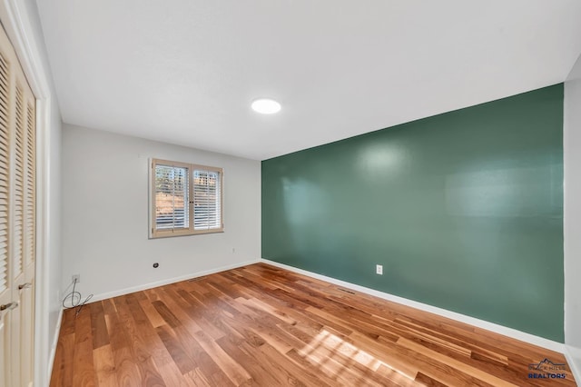 unfurnished bedroom featuring hardwood / wood-style flooring and a closet