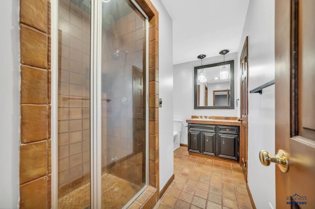 bathroom featuring vanity, toilet, and an enclosed shower