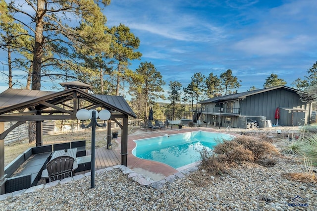 view of swimming pool featuring an outdoor bar and a wooden deck