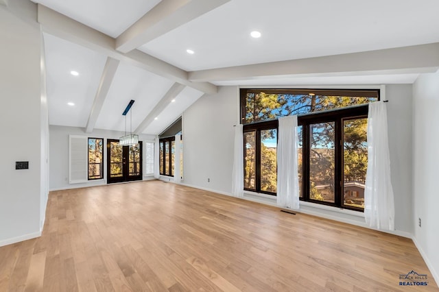 unfurnished living room with light wood-type flooring, french doors, lofted ceiling with beams, and a notable chandelier