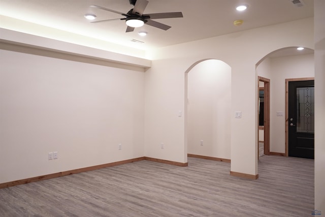 spare room featuring light hardwood / wood-style floors and ceiling fan