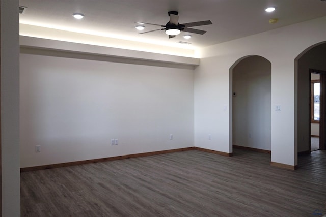 unfurnished room featuring ceiling fan and dark hardwood / wood-style flooring