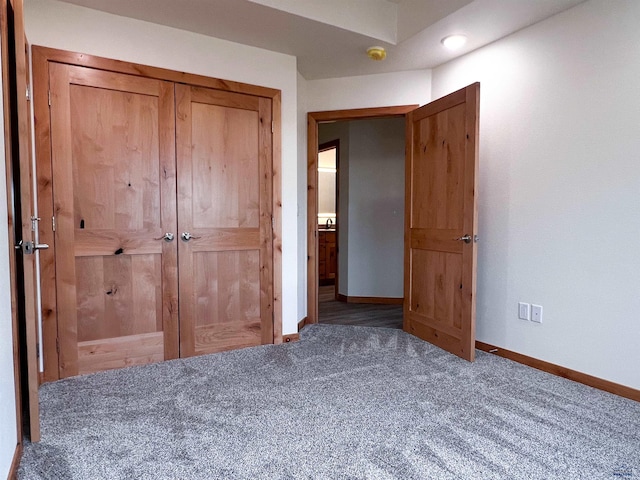 unfurnished bedroom featuring a closet and carpet