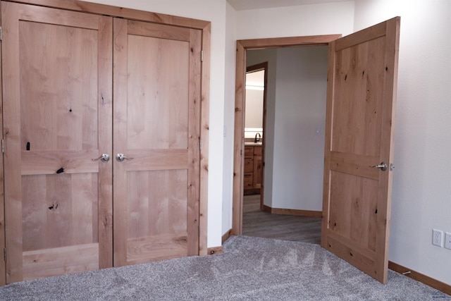 unfurnished bedroom featuring sink and light carpet