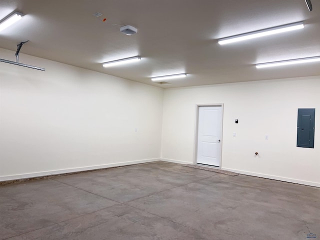 empty room featuring concrete flooring and electric panel