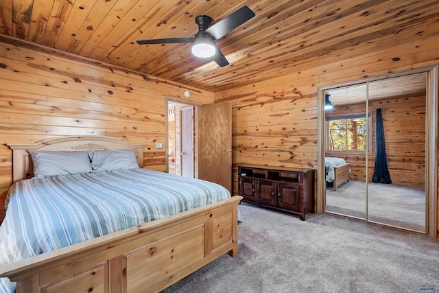 carpeted bedroom featuring ceiling fan, wood walls, and wood ceiling