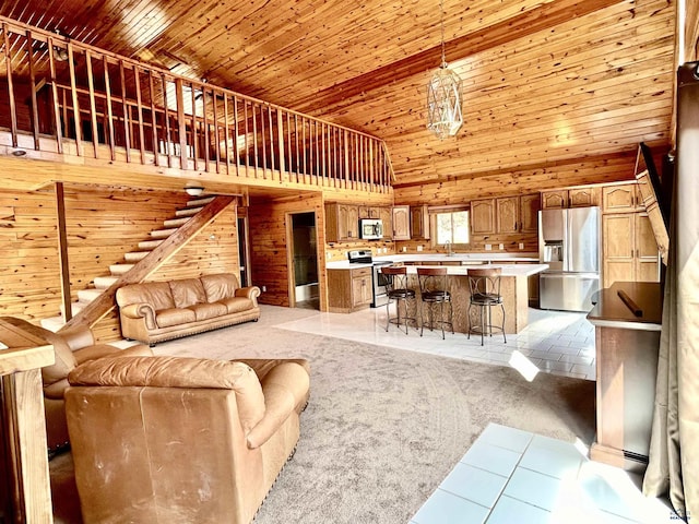 living room featuring wood ceiling, high vaulted ceiling, and light colored carpet