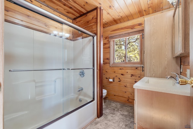 full bathroom with bath / shower combo with glass door, vanity, wooden ceiling, toilet, and wood walls