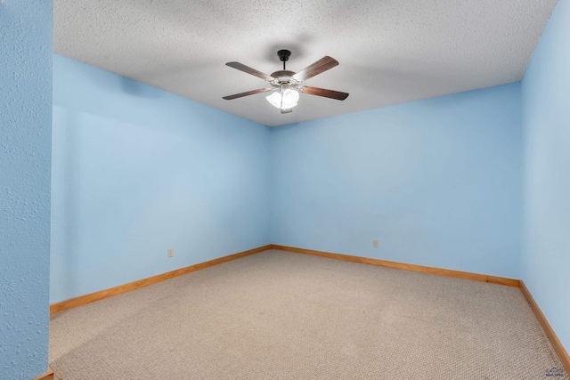 carpeted spare room featuring ceiling fan and a textured ceiling