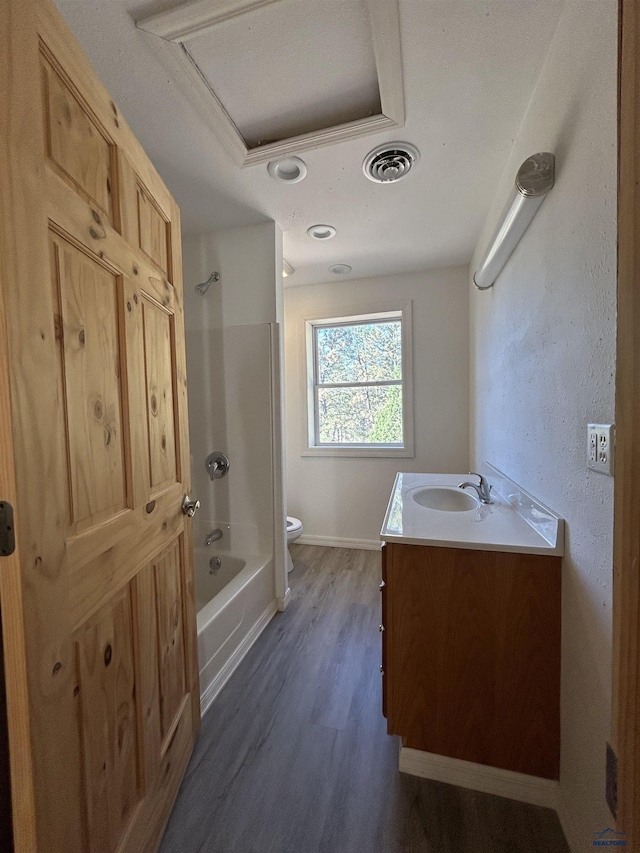 full bathroom featuring hardwood / wood-style flooring, vanity, toilet, and shower / bath combination