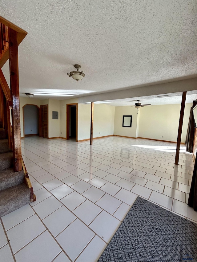 unfurnished room featuring ceiling fan and light tile patterned floors