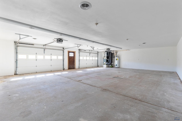 garage with a garage door opener and water heater