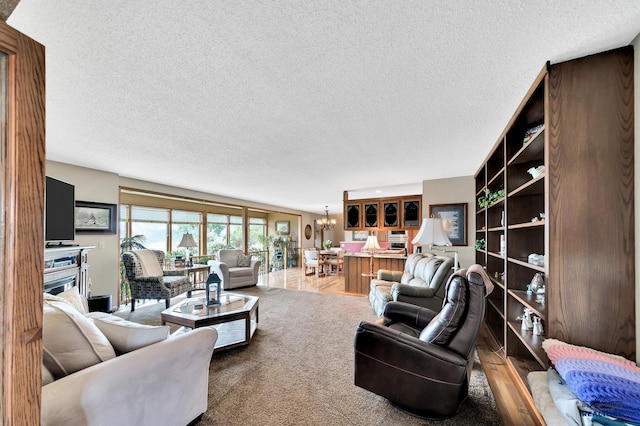 carpeted living room featuring a chandelier and a textured ceiling