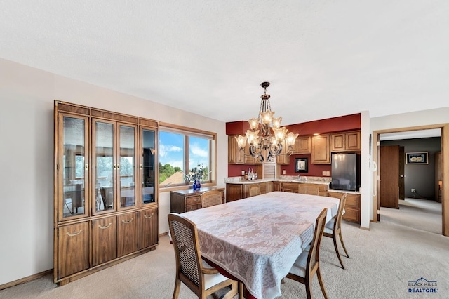 dining room featuring light carpet and an inviting chandelier