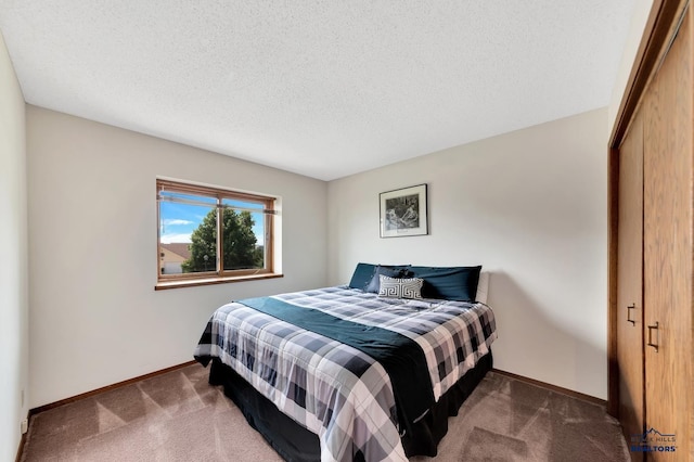 carpeted bedroom featuring a closet and a textured ceiling