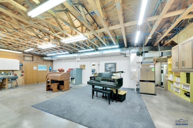 basement featuring heating unit, water heater, and wooden walls