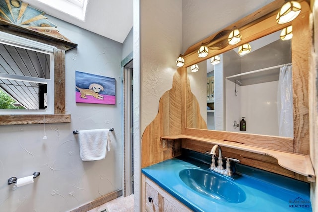 bathroom featuring vanity and curtained shower