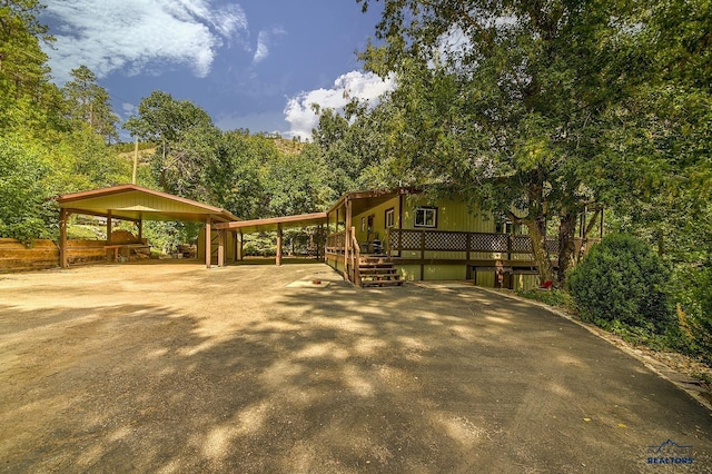 exterior space featuring a deck and a carport