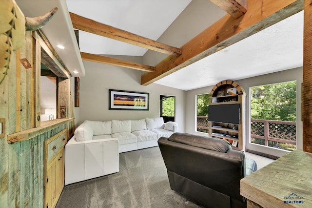 carpeted living room featuring lofted ceiling with beams