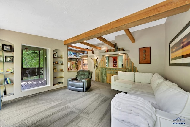 carpeted living room with built in shelves and beamed ceiling