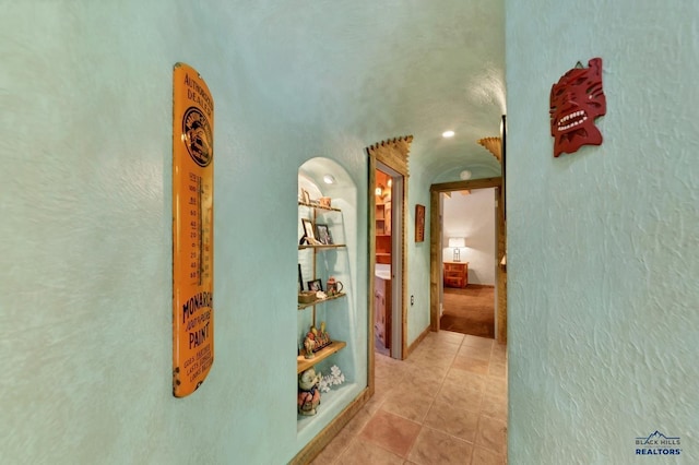 corridor featuring light tile patterned floors