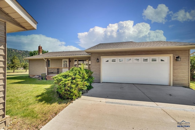 single story home with a front yard and a garage