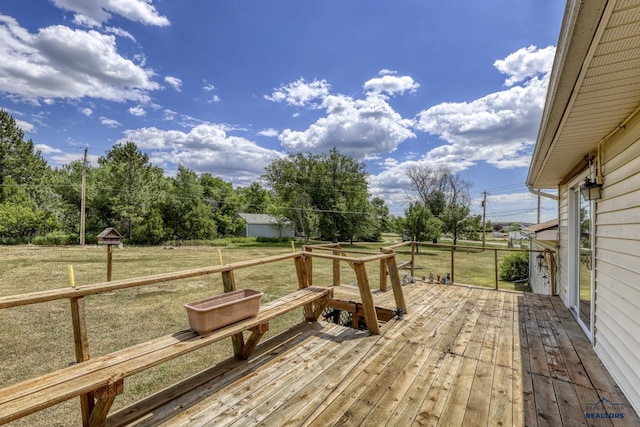 wooden terrace featuring a yard