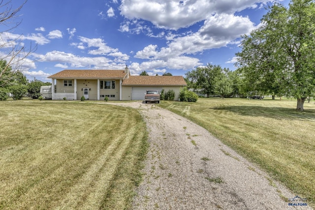 single story home with a garage and a front yard