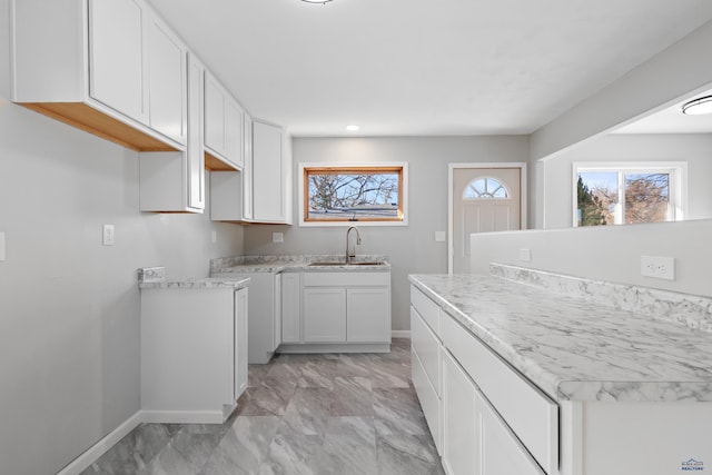 kitchen with white cabinetry and sink