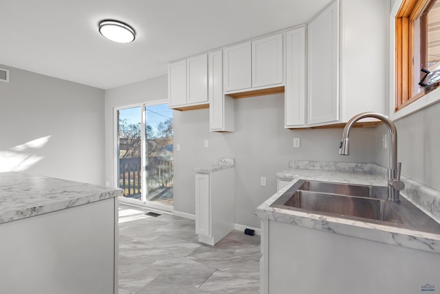 kitchen with white cabinets and sink