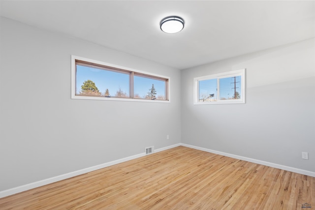 unfurnished room with light wood-type flooring