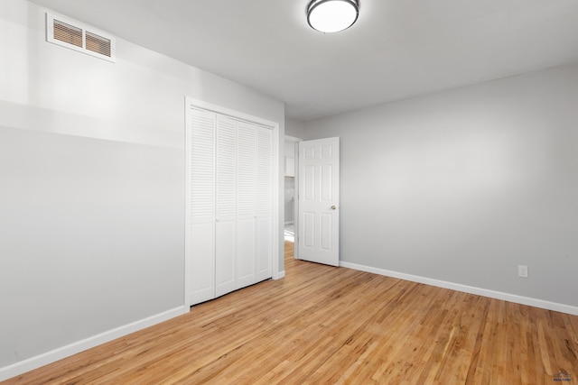 unfurnished bedroom with light hardwood / wood-style floors and a closet