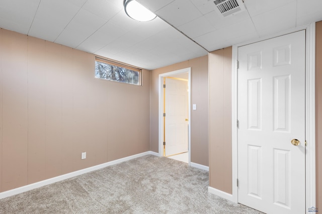 basement featuring light carpet