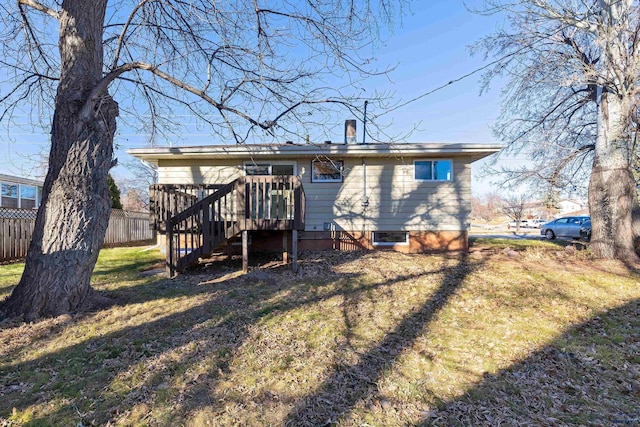 rear view of property featuring a lawn