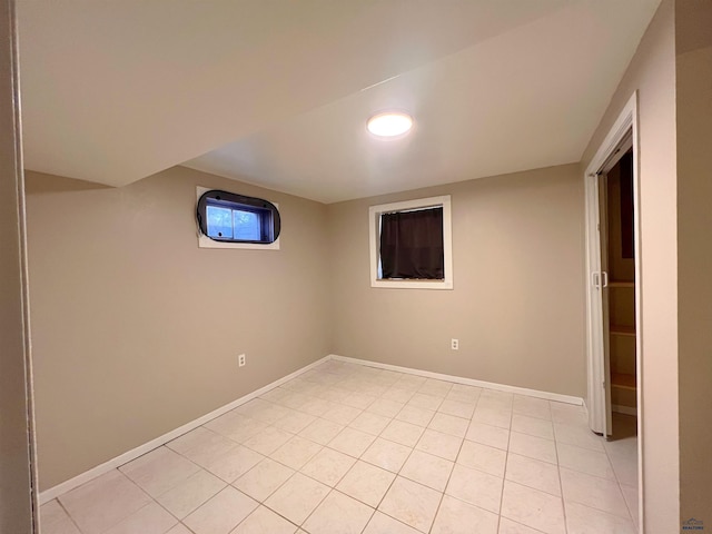 below grade area featuring light tile patterned floors and baseboards