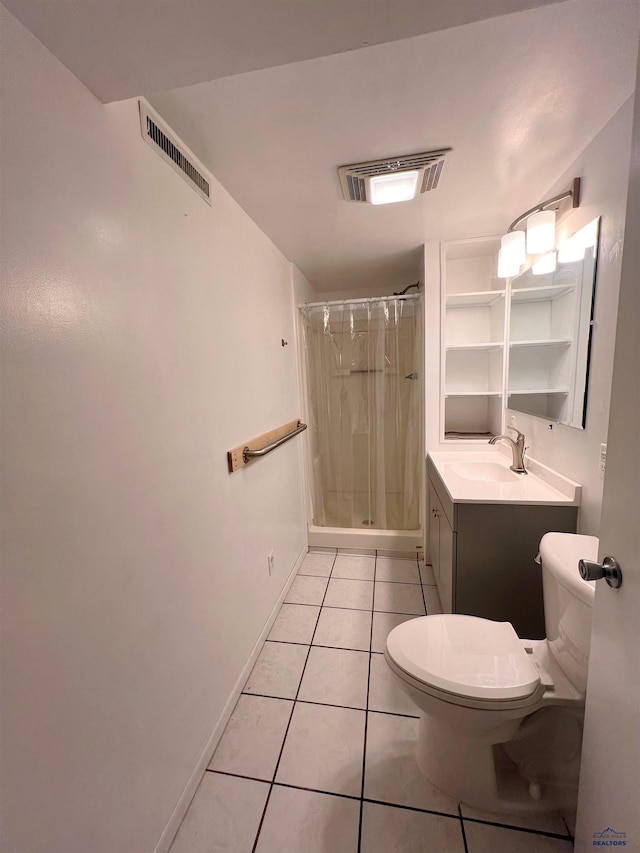 bathroom with tile patterned floors, vanity, toilet, and a shower