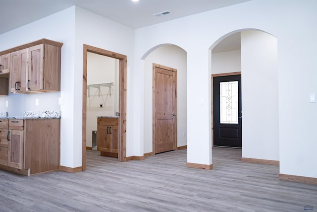 interior space featuring light hardwood / wood-style flooring and light stone counters