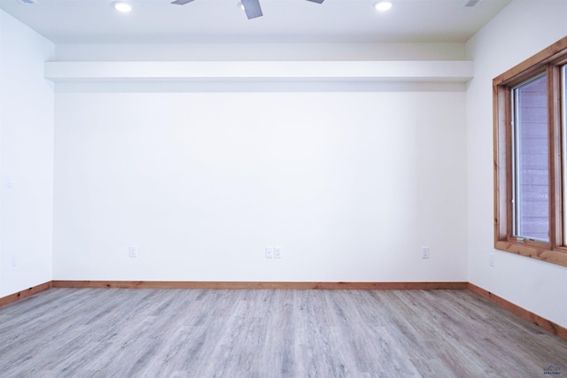 empty room featuring light hardwood / wood-style flooring and ceiling fan