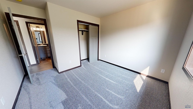 unfurnished bedroom featuring a closet and light carpet