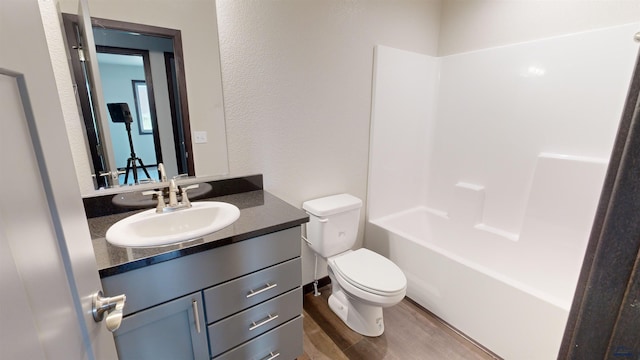 full bathroom with vanity, wood-type flooring, bathtub / shower combination, and toilet