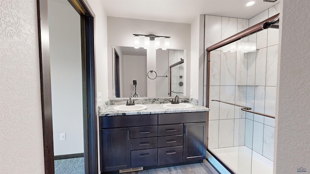 bathroom featuring vanity and a shower with shower door