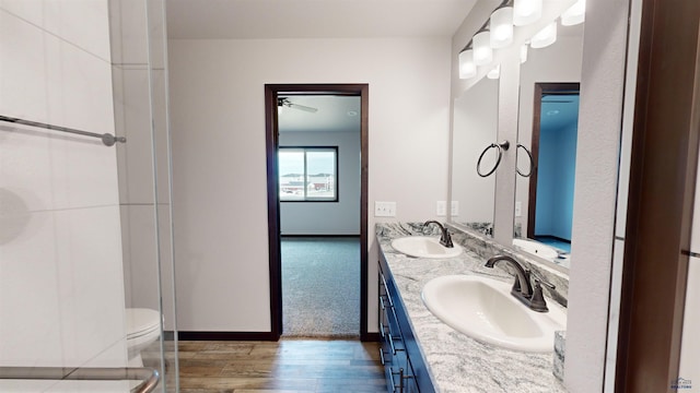 bathroom with hardwood / wood-style floors, vanity, and toilet