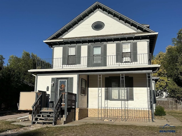 view of front of house with a porch and a balcony