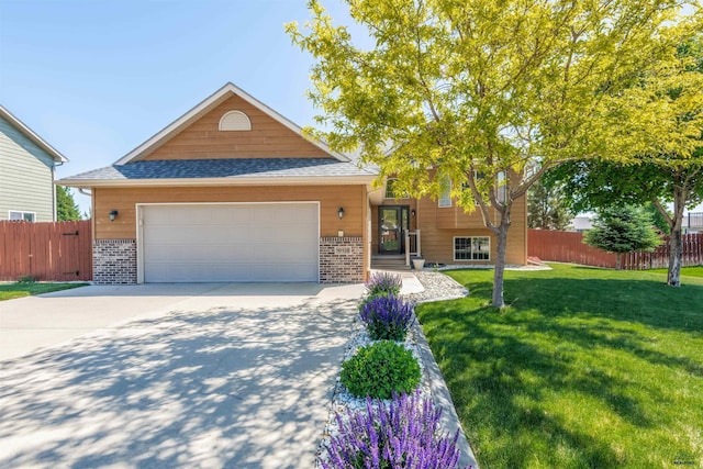 view of front of home with a front lawn and a garage