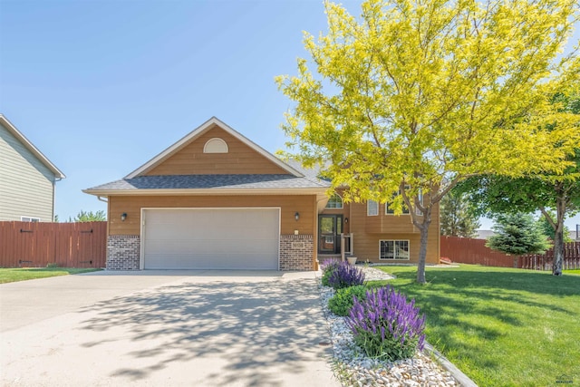 view of front of property with a front lawn and a garage