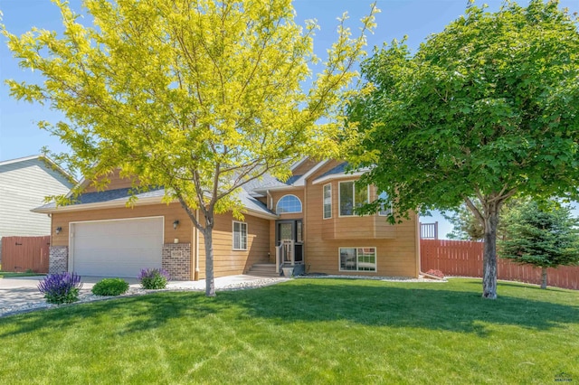 split level home featuring a front yard and a garage