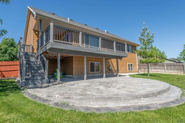 back of house featuring a deck, a patio, and a yard