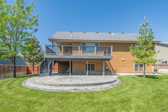 back of house with a deck, a yard, and a patio